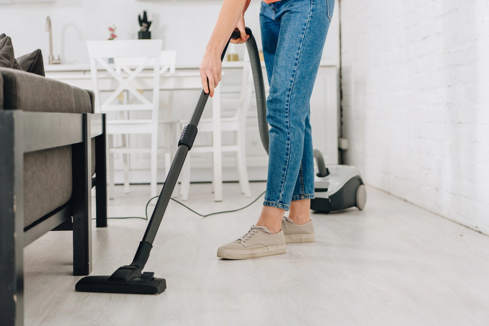 woman vacuuming the carpet in her living room